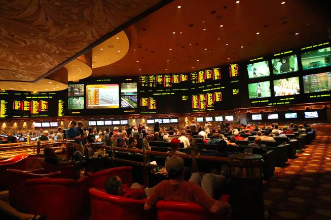 NFL football fans kick back and relax while watching NFL football games Sunday afternoon at the Mirage Race & Sports Book on October 16, 2011.